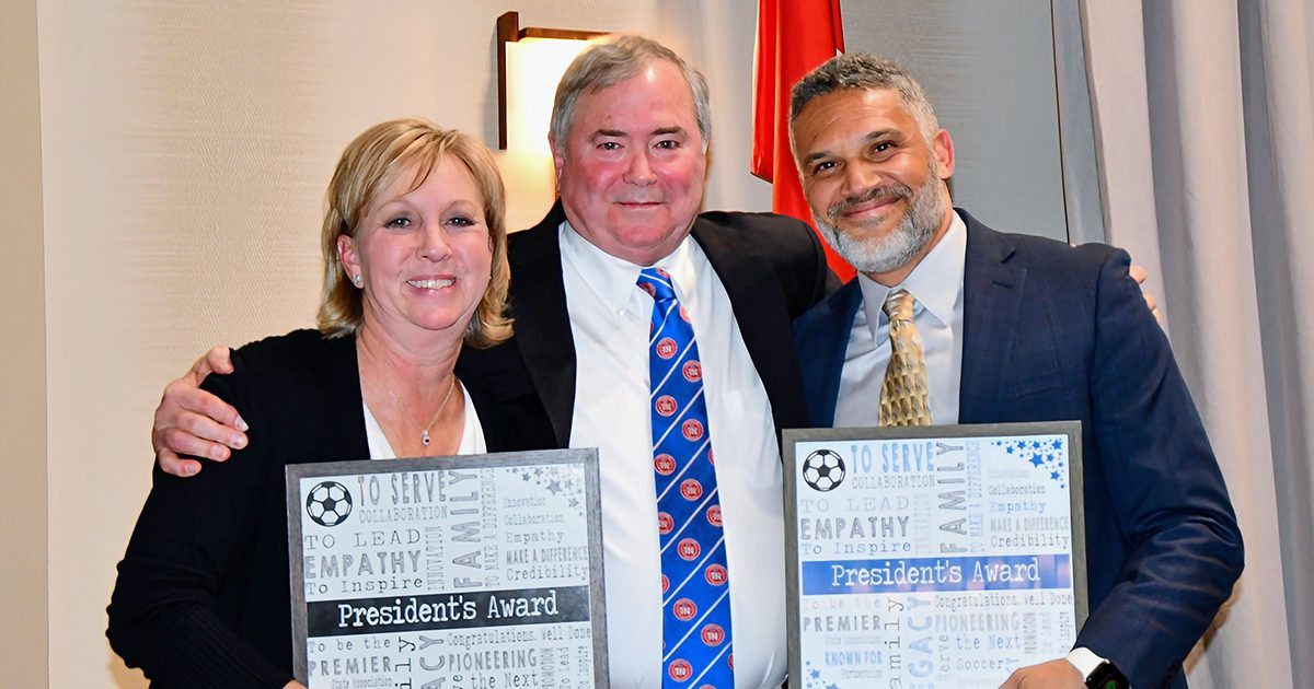 Three executives with the Tennessee State Soccer Association take a photo at the TSSA Awards Dinner.