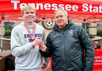 A Tennessee youth soccer player is awarded a championship medal.